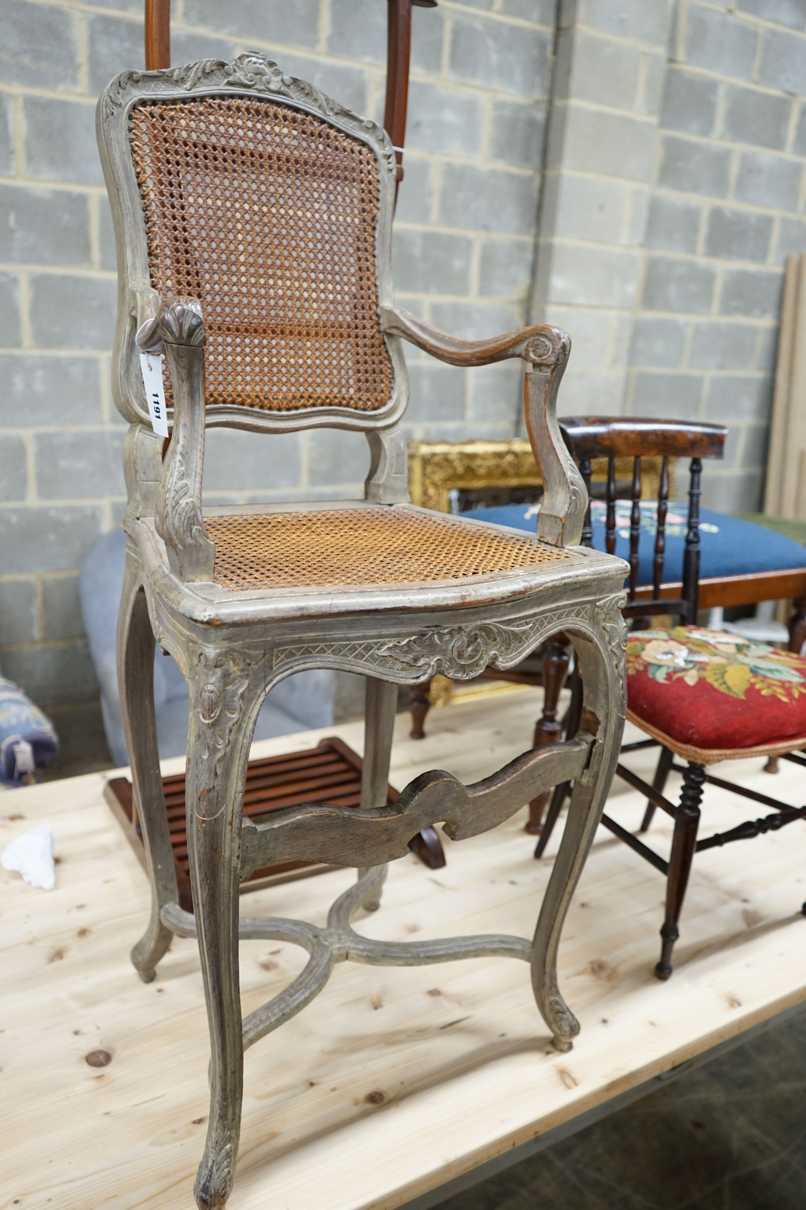 A Louis XVI design painted caned beech child's high chair together with a Victorian beech child's chair with remnants of a beadwork seat